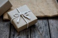 Brown paper gift box tie with rope on old wooden background