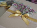 Brown paper gift box tied with a golden ribbon and decorated with dried flowers, Festival Gifts for Christmas and Happy New Year Royalty Free Stock Photo