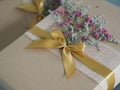 Brown paper gift box tied with a golden ribbon and decorated with dried flowers, Festival Gifts for Christmas and Happy New Year Royalty Free Stock Photo