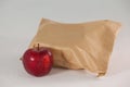 Brown paper lunch bag with red apple Royalty Free Stock Photo