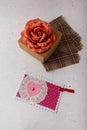 Brown paper present box, fabric rose flower, postcard with pink heart on white background. Valentines day, birthday or wedding Royalty Free Stock Photo