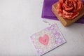Brown paper present box, fabric rose flower, postcard with pink heart on white background. Valentines day, birthday or wedding Royalty Free Stock Photo