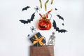 Brown paper shopping bags with Halloween decorations ad sweets on white  background Royalty Free Stock Photo