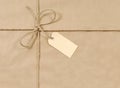 Brown paper parcel background tied with rope or string, gift tag or label, copy space Royalty Free Stock Photo