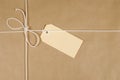 Brown parcel paper background, manila label tied with string Royalty Free Stock Photo