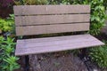 Brown park bench for rest in a garden setting