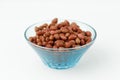Brown peanuts in a plate on a white background Royalty Free Stock Photo