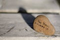 Brown pebble stone on a wooden table with the writing `You have a purpose` on it. Royalty Free Stock Photo