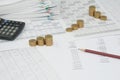 Brown pencil on balance sheet with step of gold coins Royalty Free Stock Photo