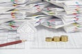 Brown pencil and house with step pile of gold coins Royalty Free Stock Photo