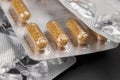 Brown pharmaceutical capsules with particles in a blister package Royalty Free Stock Photo