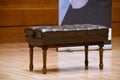 Brown piano stool on the stage in concert hall Royalty Free Stock Photo