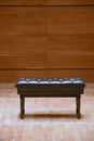 Brown piano stool on the stage in concert hall Royalty Free Stock Photo