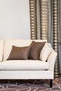 Brown pillows on empty beige sofa Royalty Free Stock Photo