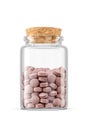 Brown pills in middle size transparent glass jar isolated on white background Royalty Free Stock Photo