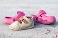 Brown and pink children`s shoes on the beach Royalty Free Stock Photo