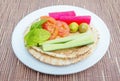Brown pita bread with sliced cucumbers,olives,tomatoes on a whi Royalty Free Stock Photo