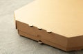 Brown pizza box on grey background. Top view Royalty Free Stock Photo