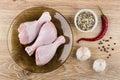 Brown plate with raw chicken legs, spices, chili pepper, garlic Royalty Free Stock Photo