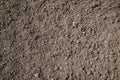 Brown plowed soil on sunlight background