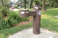 brown public double water drinking fountain with second leveraged out on cement. p