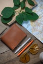 Brown purse on the table with map and sunglasses Royalty Free Stock Photo