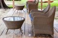 brown rattan chair and table set at a beachfront restaurant