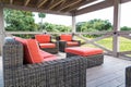 Brown Rattan Furniture with Orange Cushions