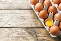 Brown raw eggs in factory packaging on rustic wooden background. Copy space Royalty Free Stock Photo