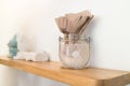 Brown Recycled Bar Napkin in glass jar on wooden shelf Royalty Free Stock Photo