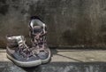 Brown Retro High Top Canvas Sneakers was placed on old cement floor. Vintage age-worn sneakers canvas shoes brown