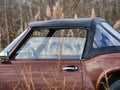 brown retromobile convertible. retro car on a field with tall dry grass