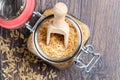 Brown rice in a bowl with wood spoon on a wooden background Royalty Free Stock Photo