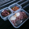 Brown rice in a box of boiled eggs with chili paste and vegetables