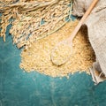 Brown rice,ear of spike and spoonful Royalty Free Stock Photo