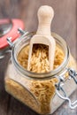 Brown rice in a glass jar with wood spoon Royalty Free Stock Photo