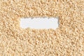 Brown rice grains forming a rectangular frame on white background Royalty Free Stock Photo