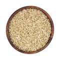 Brown rice groats in wooden bowl isolated on white background. Top view Royalty Free Stock Photo
