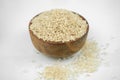 Brown rice in a wooden bowl isolated on white, horizontal studio shot Royalty Free Stock Photo
