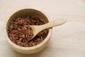 Brown rice,in a wooden bowl with wooden spoon on wood backgroun Royalty Free Stock Photo