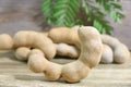 Brown ripe tamarind on wood table background in Thailand