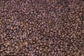 Brown roasted coffee beans, grained arabica coffee background. Espresso dark, aroma, black caffeine drink. Closeup isolated energy