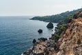 Brown rocks and sharp stones in the greenish blue water of Aegean sea near the shores of Demre city. Beautiful Turkish Royalty Free Stock Photo