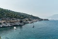 Brown rocks and sharp stones in the greenish blue water of Aegean sea near the shores of Demre city. Beautiful Turkish Royalty Free Stock Photo