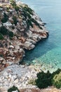 Brown rocks and sharp stones in the greenish blue water of Aegean sea near the shores of Demre city. Beautiful Turkish Royalty Free Stock Photo