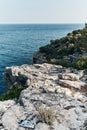 Brown rocks and sharp stones in the greenish blue water of Aegean sea near the shores of Demre city. Beautiful Turkish Royalty Free Stock Photo