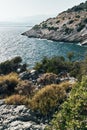 Brown rocks and sharp stones in the greenish blue water of Aegean sea near the shores of Demre city. Beautiful Turkish Royalty Free Stock Photo