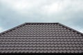 Brown roof tiles or shingles on house as background image. New overlapping brown classic style roofing material texture pattern o Royalty Free Stock Photo