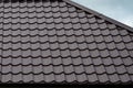 Brown roof tiles or shingles on house as background image. New overlapping brown classic style roofing material texture pattern o Royalty Free Stock Photo