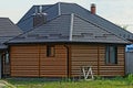 Brown rural wooden log house with tiled windows Royalty Free Stock Photo